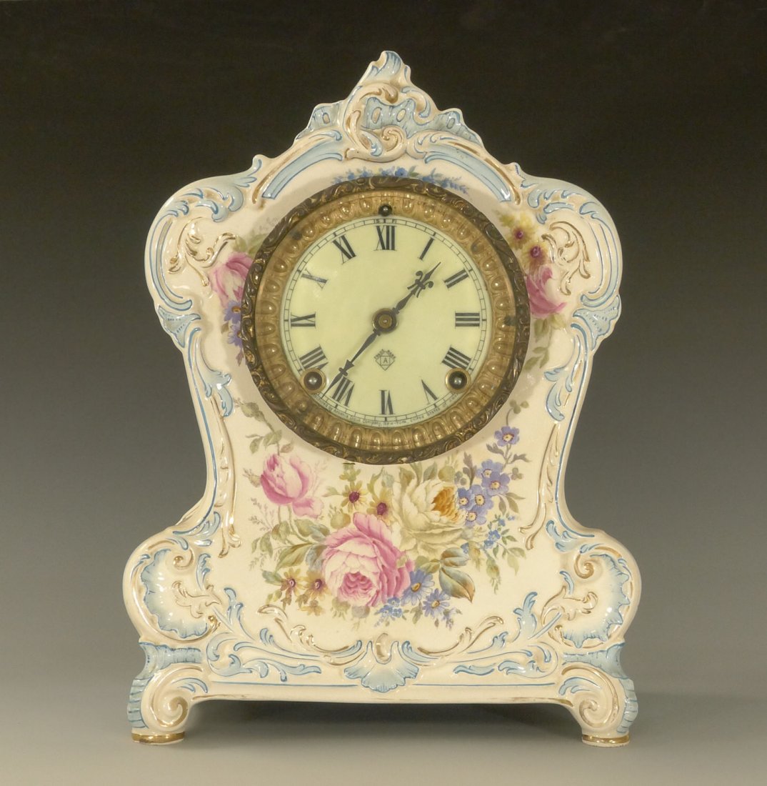 ANTIQUE ANSONIA LA CLAIR MODEL CLOCK: Ansonia Royal Bonn, "La Clair" porcelain mantel clock in very good condition. This is a very rare model according to the Millers.The case is primarily ivory with almost half being a very light blue ar