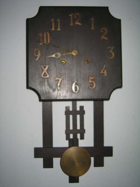 MISSION OAK WALL CLOCK. NATIONAL CLOCK CO. CHICAGO: MISSION OAK WALL CLOCK. MFG. BY NATIONAL CLOCK COMPANY, CHICAGO. BRASS NUMERALS & HANDS. APP. 26"L x 14 1/2"W. GC