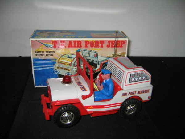 JUNIOR TV AIRPORT JEEP IN BOX W/MYSTERY ACTION: JUNIOR TV AIRPORT JEEP IN BOX. BATTERY POWERED MYSTERY ACTION WITH SIREN SOUND, REAR SCREEN REPRODUCE RUNWAY SCENE. JEEP READS "AIR PORT SERVICE". GREY/RED. RUBBER PERSON IN DRIVER SEAT. EXCELLENT CON