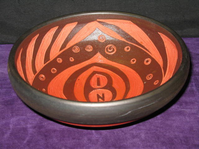 NATALIE BLAKE CARVED POTTERY VESSEL. ORANGE/: NATALIE BLAKE CARVED POTTERY VESSEL, ORANGE/BLACK. 8"X8", 3"H.