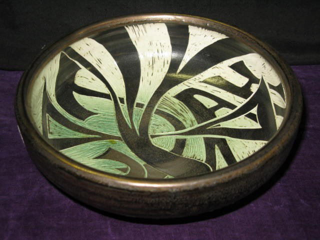 NATALIE BLAKE CARVED POTTERY BOWL: NATALIE BLAKE CARVED POTTERY BOWL. GREEN/BLACK/CREAM. VGC. 8"X8", 3"H.