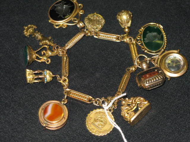 CHARM BRACELET, APP. 97.6 GRAMS 14KT TOTAL WEIGHT: CHARM BRACELET WITH INTAGLIO, ETC. APP. 97.6 GRAMS 14KT TOTAL WEIGHT. CHARMS INCLUDE CARNELION WHICH IS A LOCKET, BLOOD STONE,AGATE, CRISTOFFE, ETC.