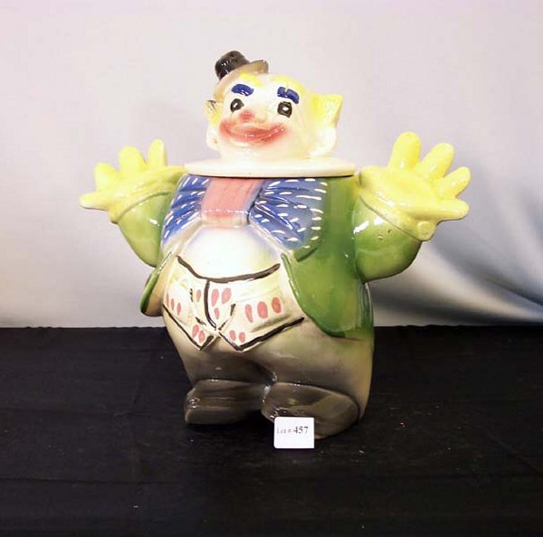 CLOWN COOKIE JAR "JD19-MAURICE": CLOWN COOKIE JAR "JD19-MAURICE". California. Super oversized Clown wearing green jacket, yellow gloves, big bow. Crackle glaze.