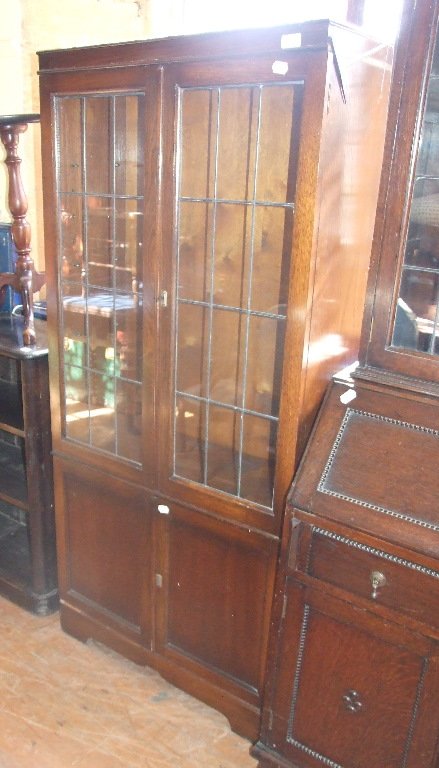 An Ercol style bookcase, 182 cm wide, and an oak: An Ercol style bookcase, 182 cm wide, and an oak bookcase (2)