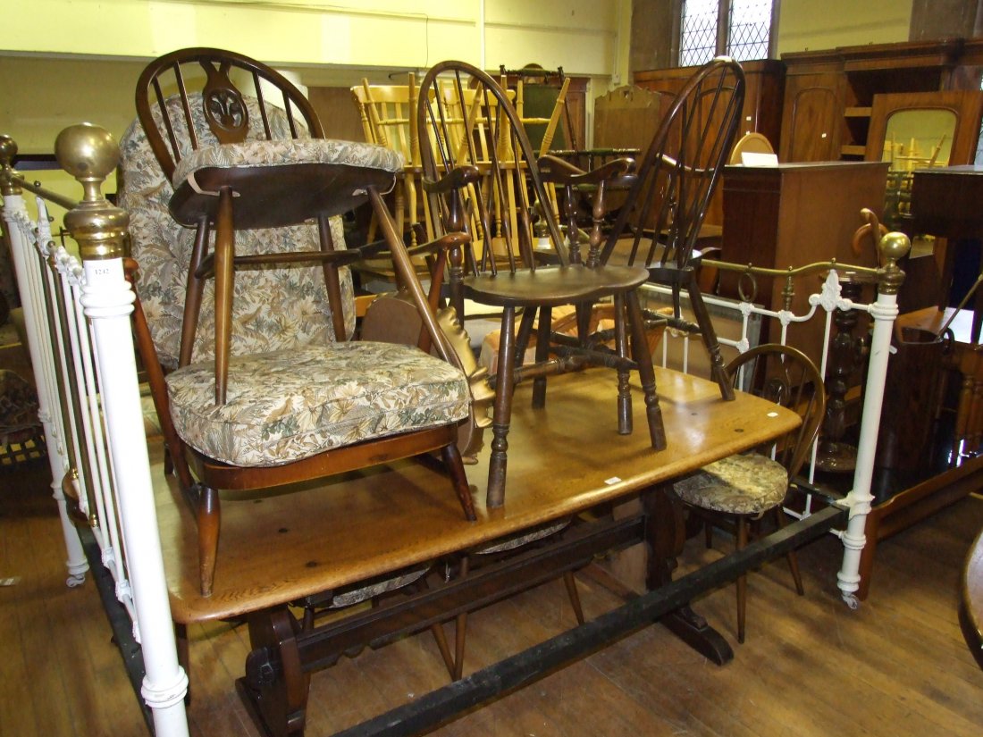An Ercol refectory style table, 180 cm wide, six: An Ercol refectory style table, 180 cm wide, six similar chairs, a spinning wheel, and two mirrors (10)