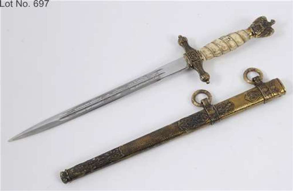 A German naval officer's dagger, the blade with: A German naval officer's dagger, the blade with engraved decoration and signed Horster, Solingen See inside back cover colour illustration See general disclaimer on Third Reich items ‘Please note th