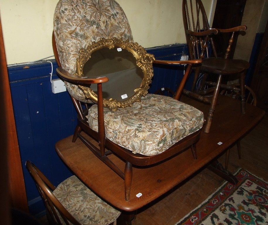An Ercol dining table, 180 cm wide, a set of four: An Ercol dining table, 180 cm wide, a set of four similar chairs, three other chairs, and a mirror (9)