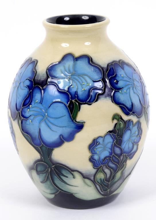 A Moorcroft pottery vase, decorated blue flowers, Jan 17, 2014