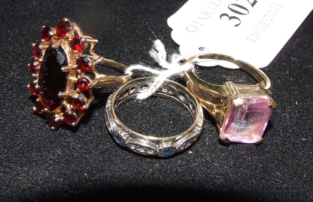 A 9ct gold and garnet cluster ring, and two other rings: A 9ct gold and garnet cluster ring, and two other rings (3)