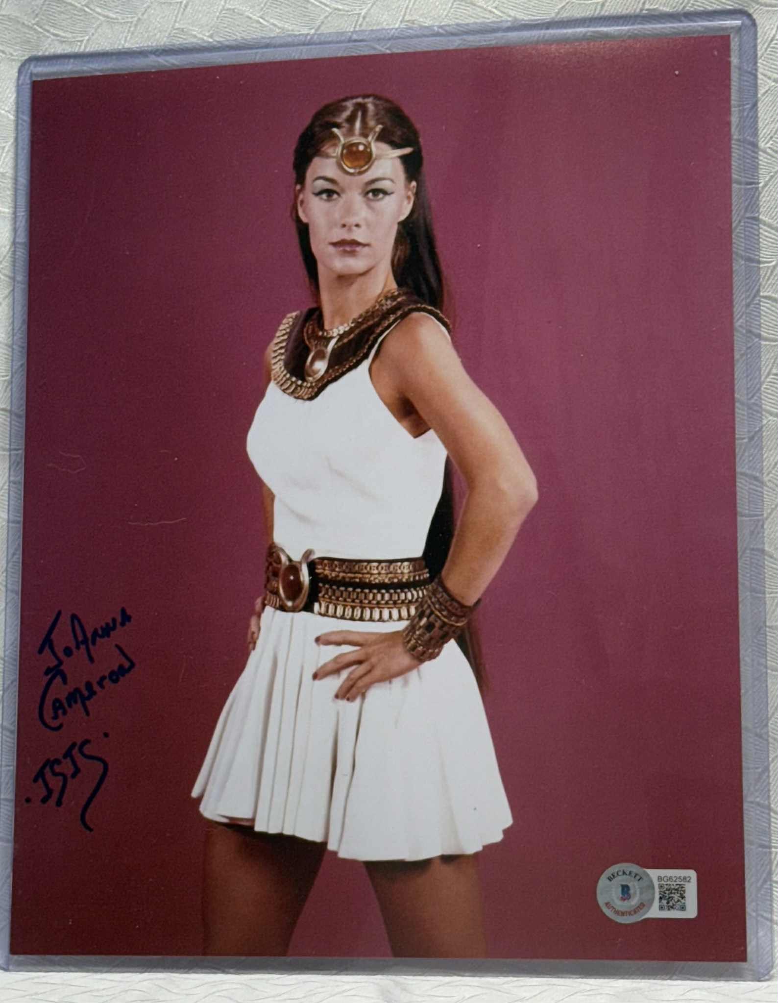 JoAnna Cameron Signed 8×10 Photo as “Isis” — Beckett Certified (Sticker Only): Original color 8×10 photograph of actress JoAnna Cameron in her role as Isis from the classic 1970s television series “The Secrets of Isis.” Boldly signed in black marker, “JoAnna Cameron �
