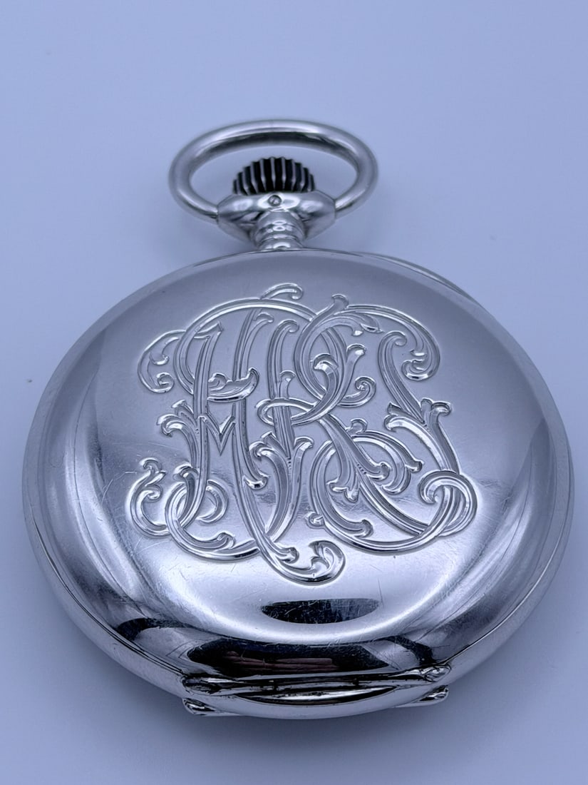 Longines Silver Pocket Watch, Swiss Manual Wind, Early 20th Century: An elegant early 20th century Swiss pocket watch by Longines, featuring a clean white enamel dial with Arabic numerals, subsidiary seconds, and blued steel hands. The watch is housed in a finely finis