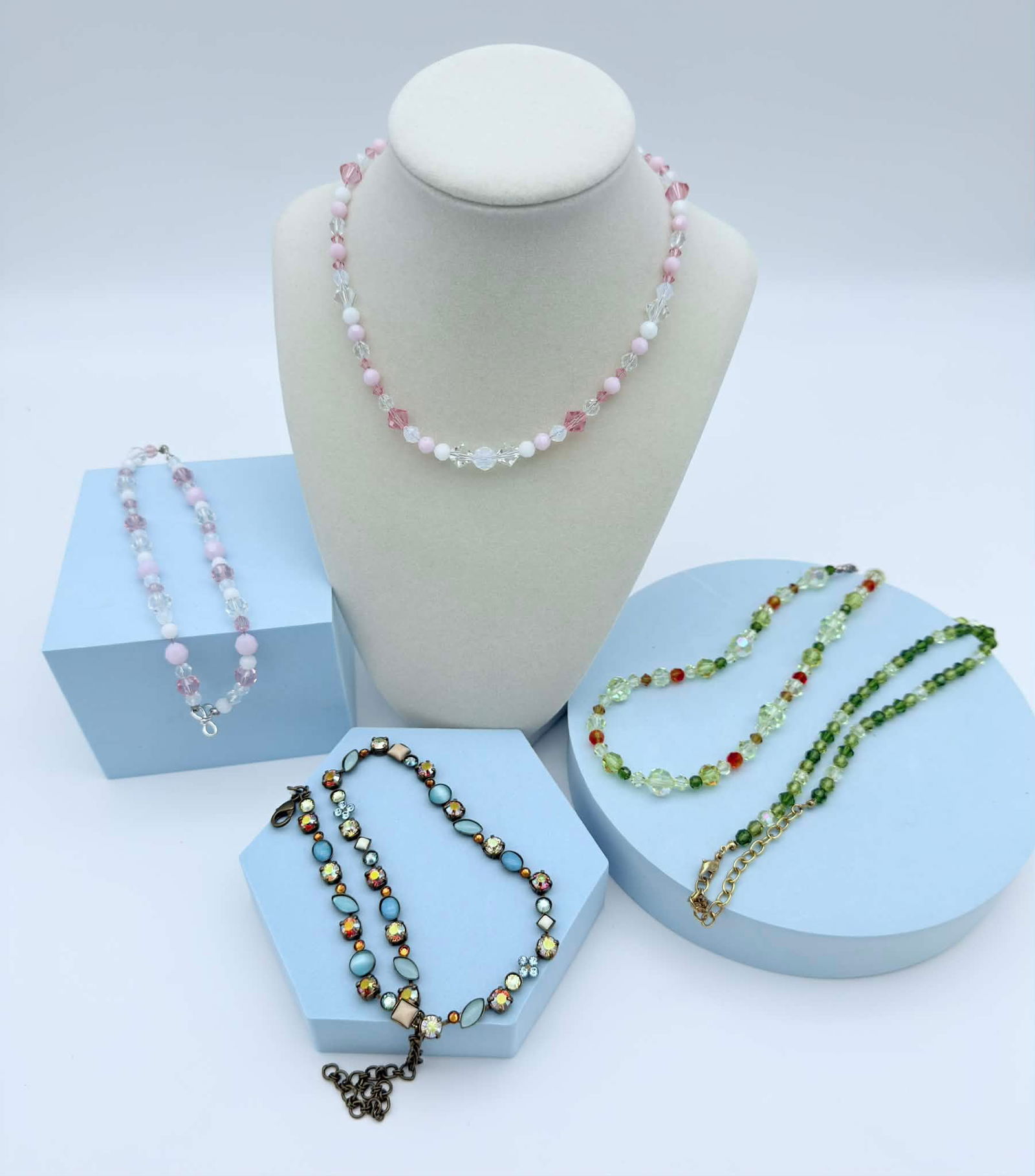 Lot of Three Contemporary Beaded Jewelry Necklaces Including Sorrelli: A mixed lot of three beaded necklaces featuring pastel pink, green, and multicolor crystal-style beads. Includes a pink and clear faceted bead necklace, two green-toned crystal bead necklaces with mix