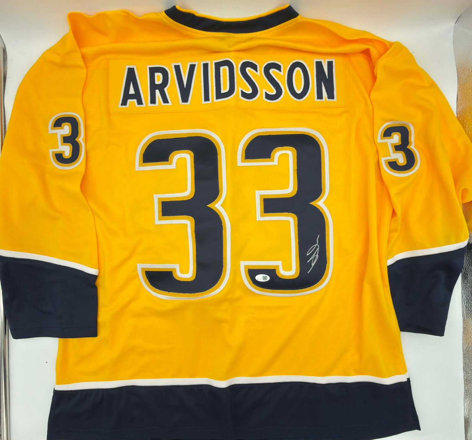Viktor Arvidsson Signed Nashville Predators Jersey – No. 33 – Authenticated: Autographed Nashville Predators hockey jersey signed by Viktor Arvidsson, a key contributor during the Predators’ most successful modern-era seasons. The signature is boldly applied in silver marker