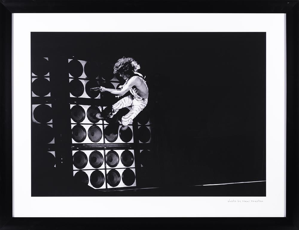 Eddie Van Halen Concert Photograph by Neal Preston, Framed, Hard Rock Hotel Las Vegas: Authentic Hard Rock Hotel & Casino Las Vegas photographic print depicting Eddie Van Halen, captured in performance by legendary rock photographer Neal Preston. This iconic image—showing Van Halen ai