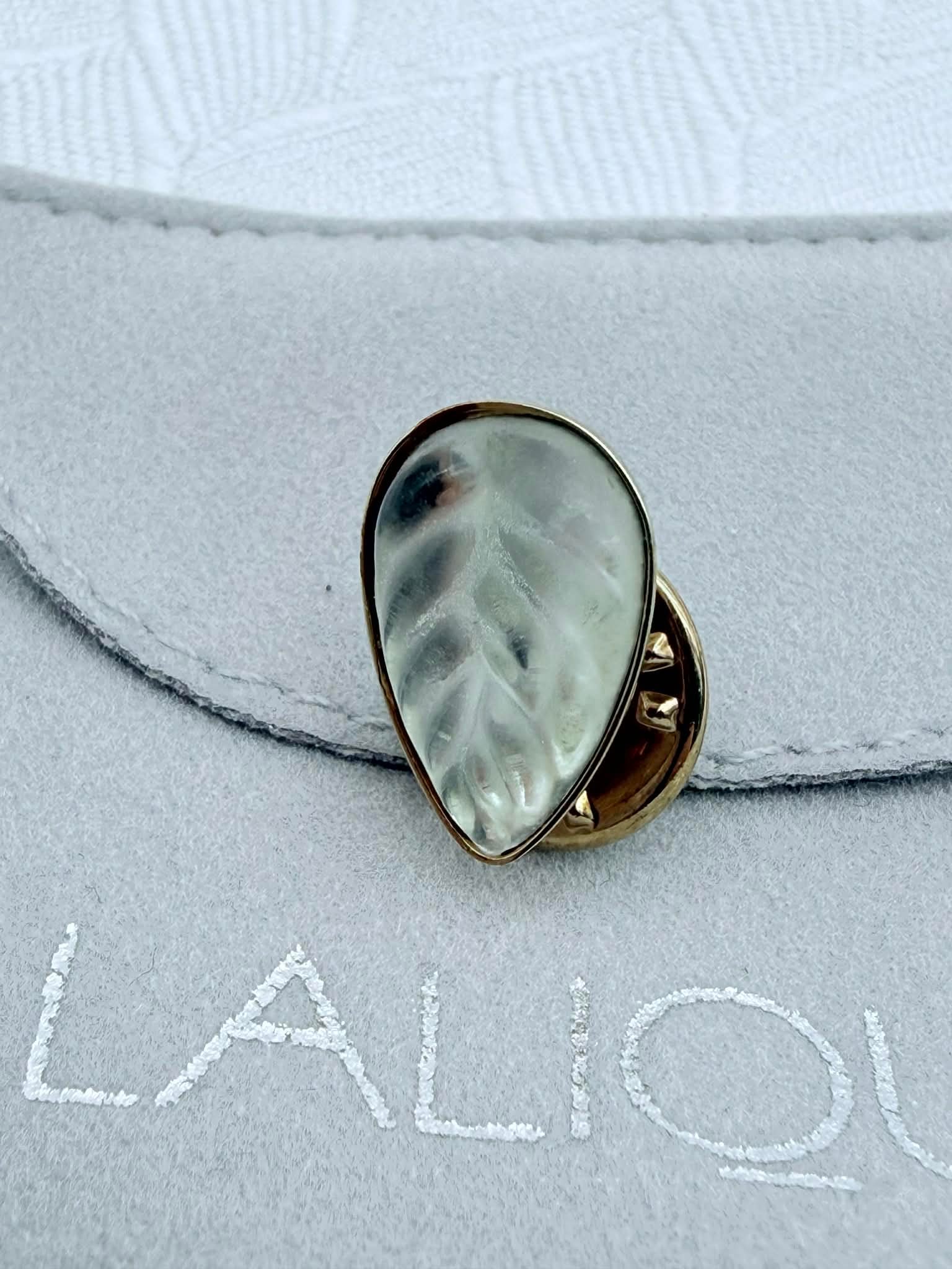 Authentic Lalique Heliconia Crystal Pin, 2000, Paris - Presentation Box: Authentic Lalique Paris Heliconia pin featuring a finely chiselled clear crystal teardrop inspired by an exotic tropical flower. This design was created to commemorate the Lalique exhibition held in J