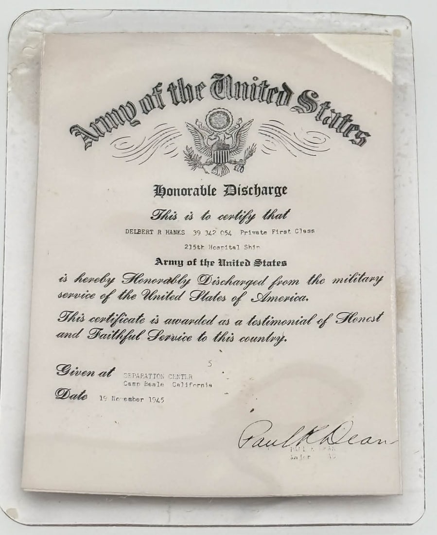 WWII U.S. Army Honorable Discharge Document – 1945 Camp Beale, Named Soldier: Original World War II-era U.S. Army honorable discharge certificate issued in 1945, accompanied by the soldier’s Enlisted Record and Report of Separation. The document is issued to Delbert R. Hanks,