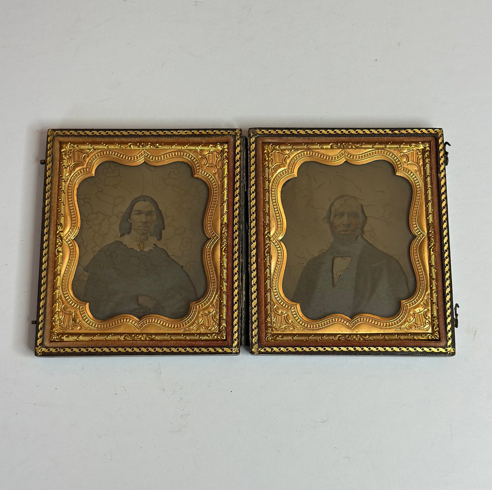 Antique Tintype Photograph Man in Union Case Civil War Era Portrait: An antique tintype photograph portrait housed in a decorative Union case, depicting a young man in formal attire including jacket, vest, and bow tie. The image is presented within an ornate gilt metal