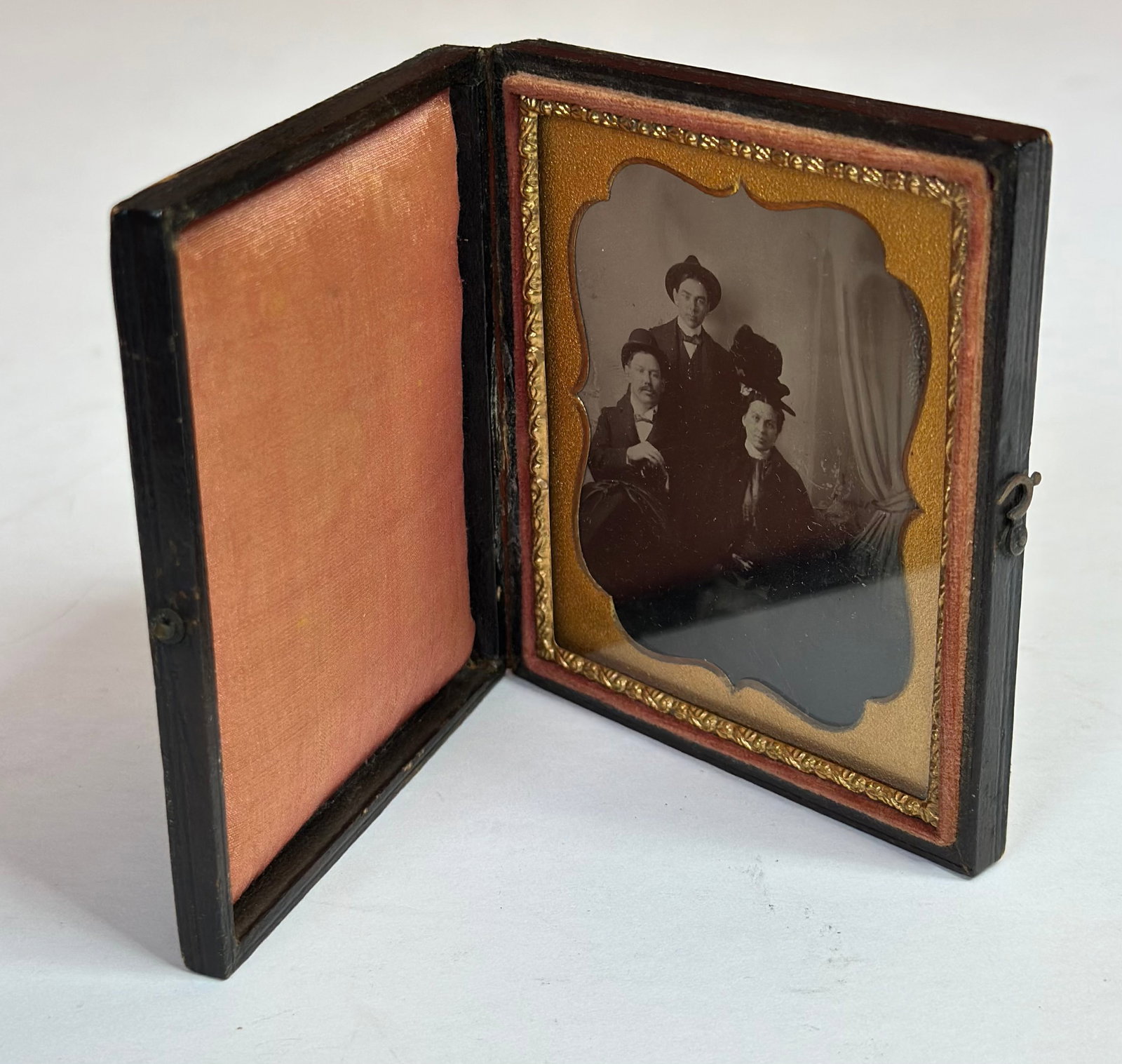 Antique Victorian Daguerreotype Group Portrait of Three Men in Union Case: Antique Victorian daguerreotype featuring a group portrait of three men, housed in a molded Union case with floral motif exterior. The image shows three seated and standing gentlemen in period attire,