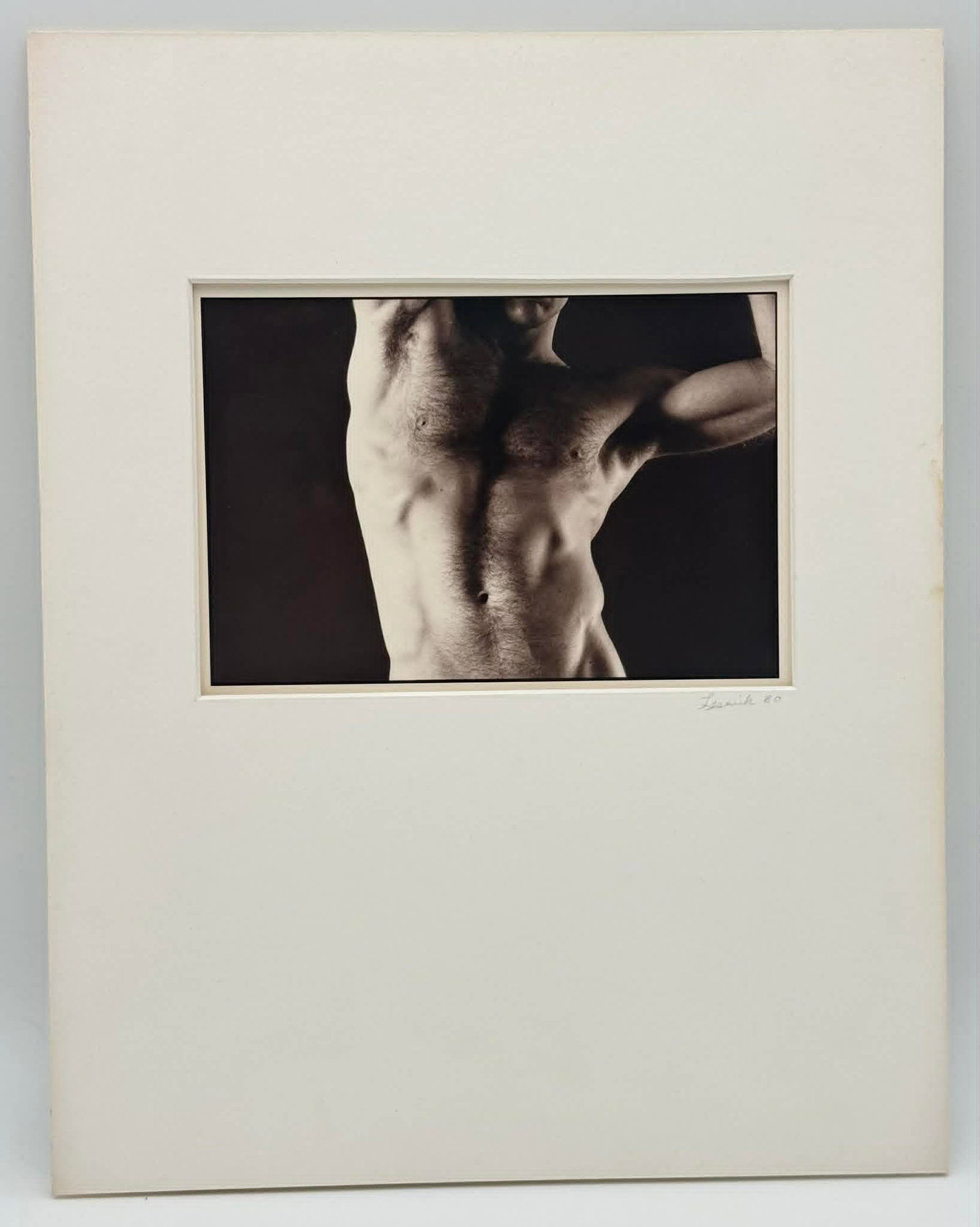 John Lesnick Male Torso Photograph 1980 Signed Limited Edition 4/5 Nude Study: Untitled (male torso), a black-and-white photographic study by John Lesnick, dated 1980. The composition presents a cropped male figure with strong directional lighting, emphasizing musculature, shado