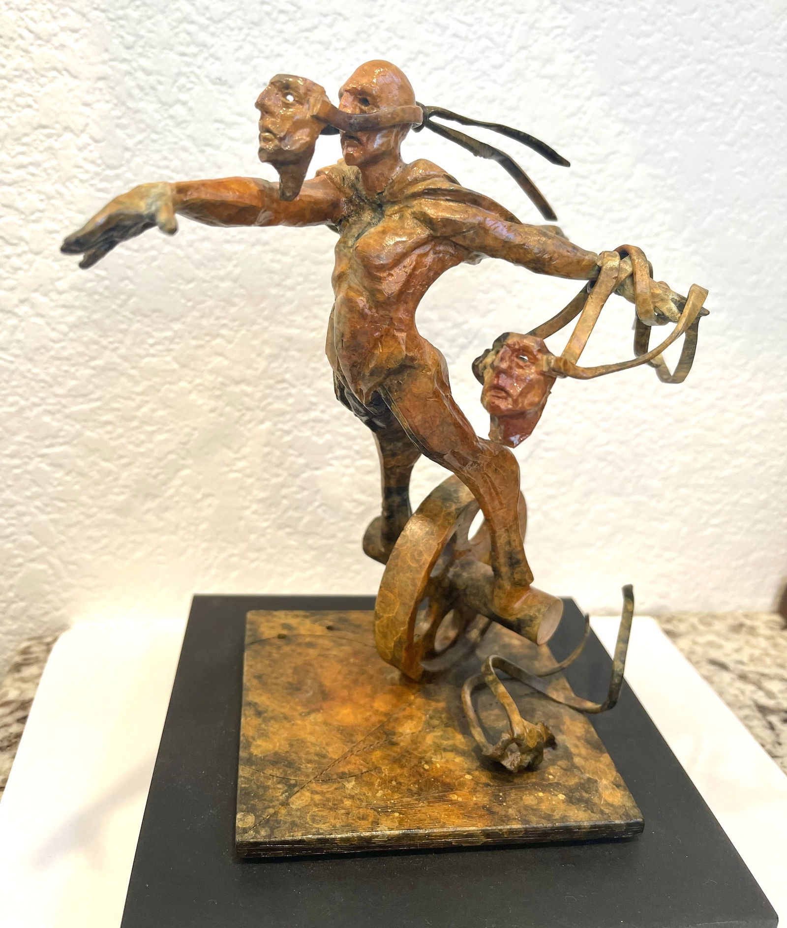 Theodore “Ted” Gall Bronze Figural Sculpture, “Man with Wheel,” Signed and Dated: Expressive bronze sculpture by American artist Theodore “Ted” Gall depicting a stylized human figure balanced atop a wheel motif. The elongated figure extends outward with ribbon-like forms fl