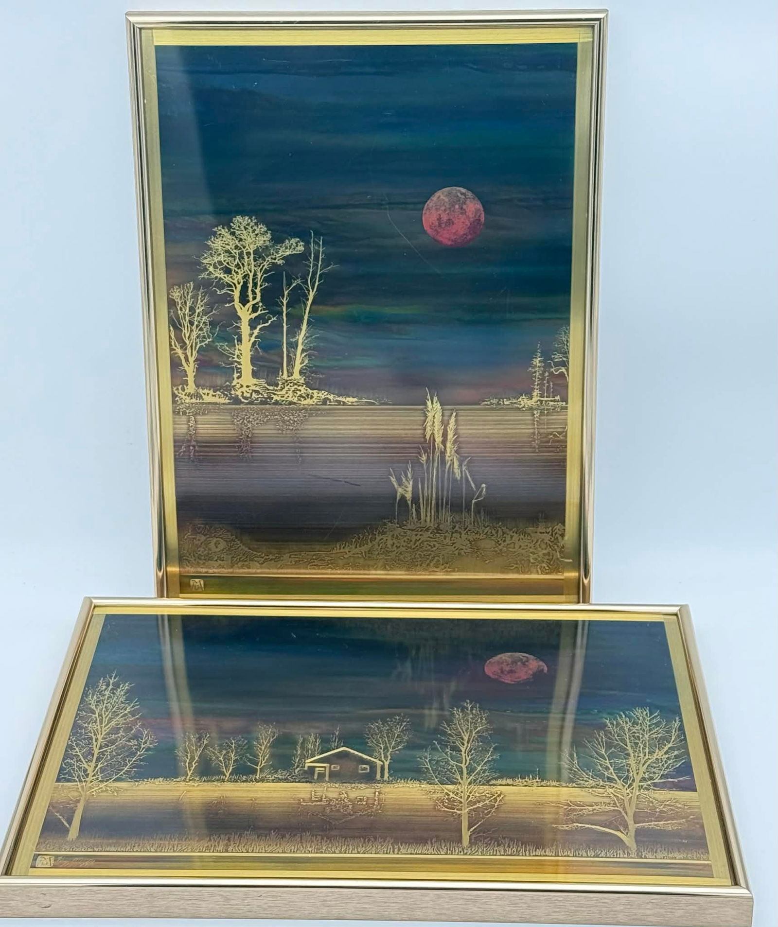 Pair of Bernhard Rohne Acid-Etched Metal Panels, “Lakeside” & “Cabin on the Creek": Pair of acid-etched metal wall panels after designs by Bernhard Rohne, produced by Metallic Design Studio of Metal Etching Ltd., North Vancouver, Canada. The panels depict stylized moonlit landscape s