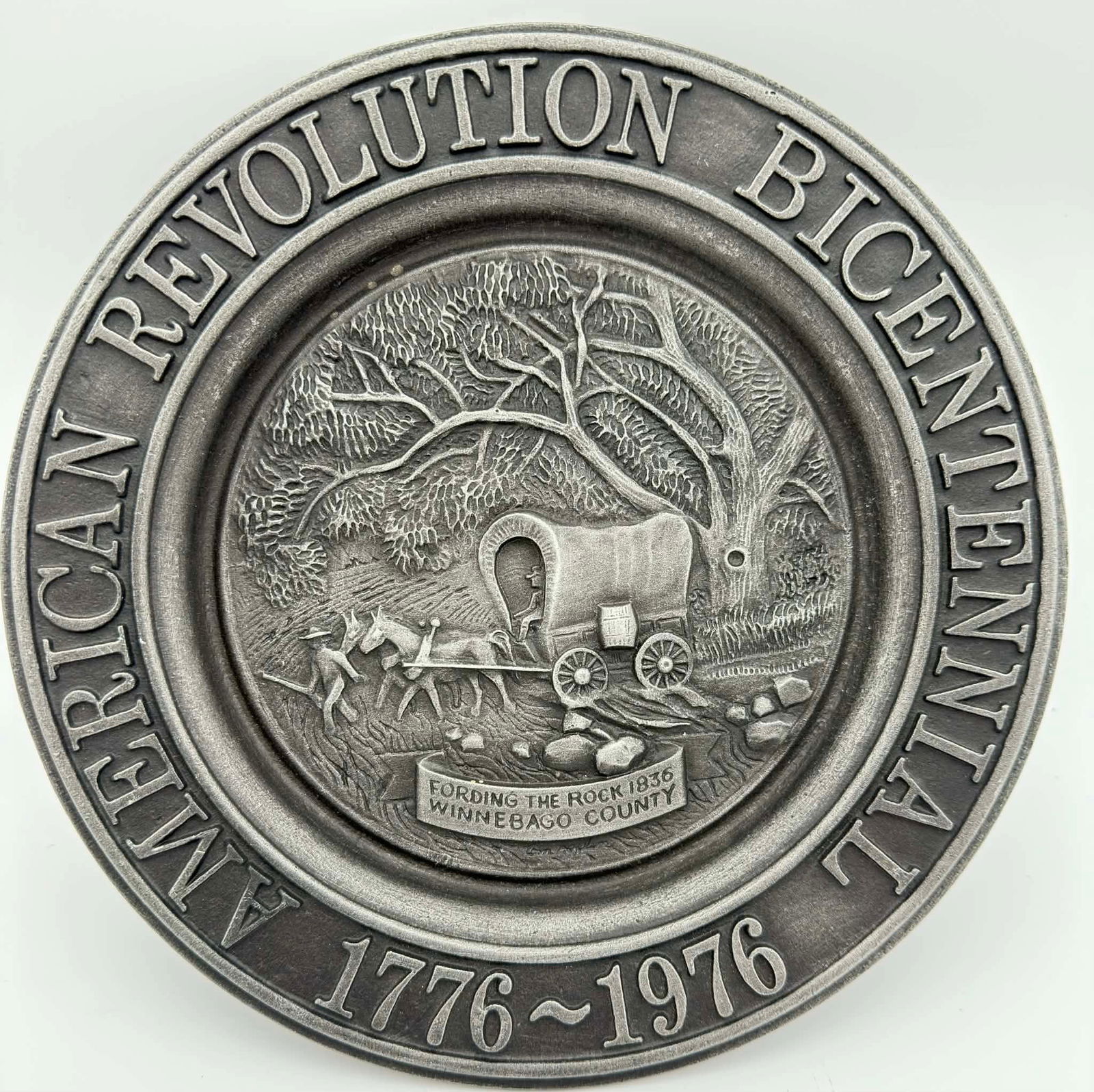 1976 American Revolution Bicentennial Pewter Plate, Winnebago County Limited Edition 567/1000: Commemorative 1976 American Bicentennial pewter plate issued by the Winnebago County Bicentennial Commission, marking the 200th anniversary of the American Revolution (1776–1976). The plate features