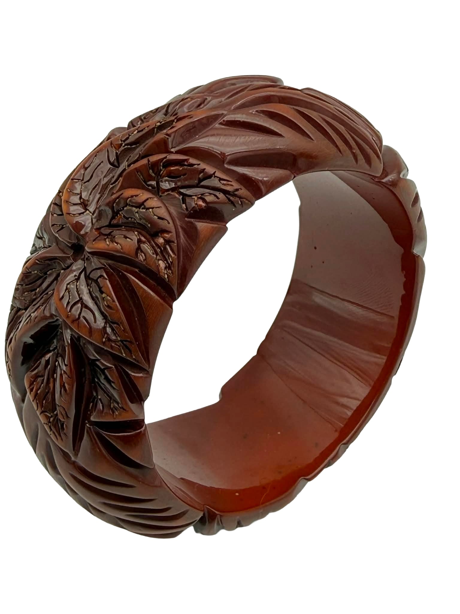 Deeply Carved Catalin (Bakelite) Bangle Bracelet – New York Studio, Warhol-Era Associated: A striking vintage Catalin (phenolic resin, commonly referred to as Bakelite) bangle bracelet from a New York studio collection, featuring deeply carved geometric and foliate motifs in warm amber and