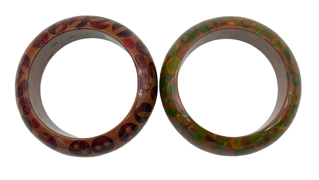 Rare Catalin (Bakelite) Bangles Inside Carved “Button” Dots – New York Studio, Warhol-Era: A rare pair of vintage Catalin (phenolic resin, commonly referred to as Bakelite) bangle bracelets from a New York studio collection, each featuring vintage art deco buttons embedded in Catalin Bakeli
