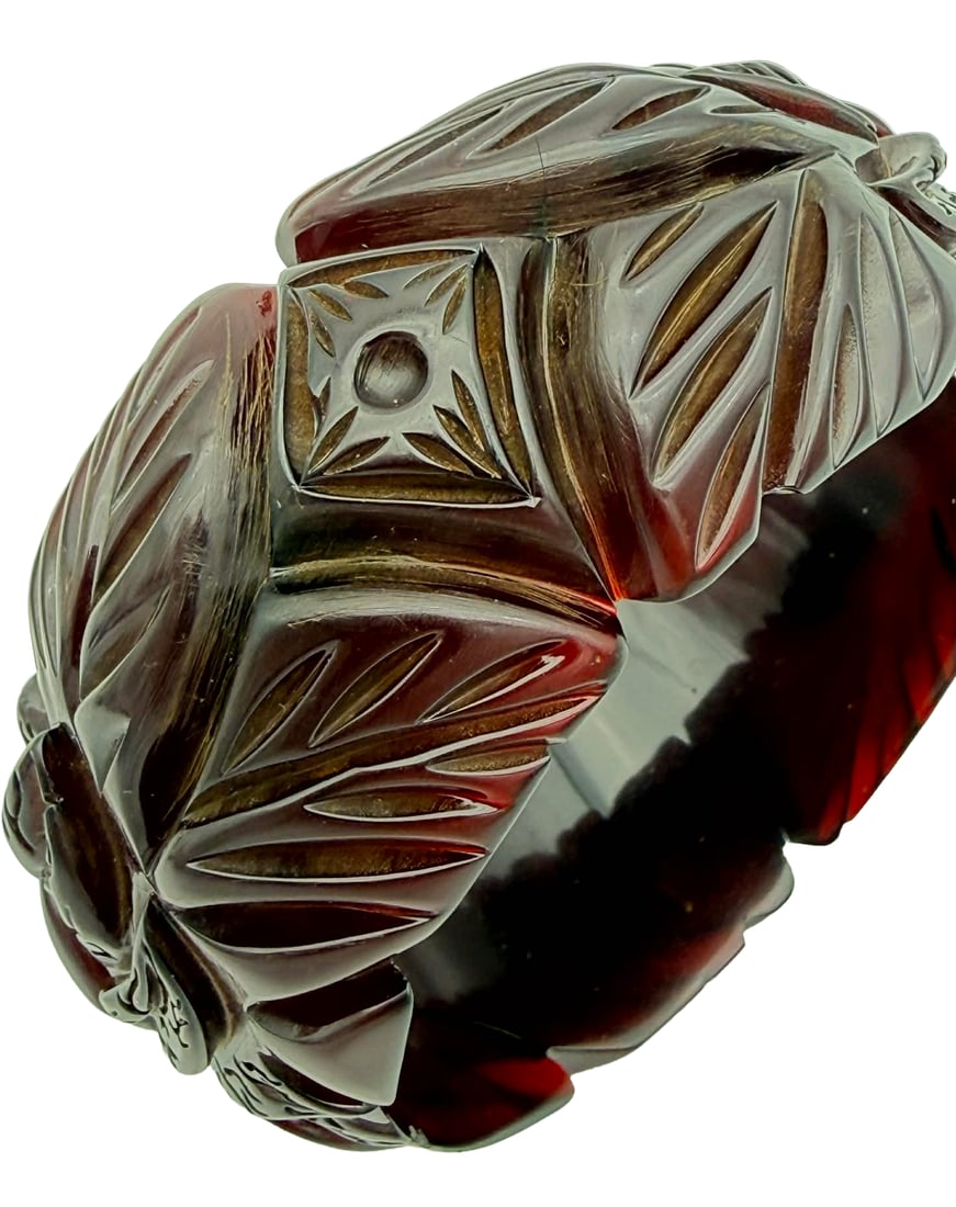 Carved Catalin Bangle Bracelet with Dot Panel Motif, 1930s–1940s – New York Studio Collection: Vintage carved Catalin bangle bracelet dating to the 1930s–1940s, featuring a combination of foliate carving and geometric panel elements centered by a raised dot motif. The design incorporates both