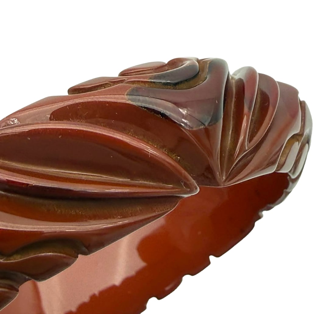 Carved Bakelite Bangle Bracelet with Dot & Fan Motif, 1930s–1940s: Vintage carved Bakelite bangle bracelet dating to the 1930s–1940s, featuring a flowing design of fan-shaped and foliate elements accented by raised dot motifs. The carving is smooth and rounded, cre