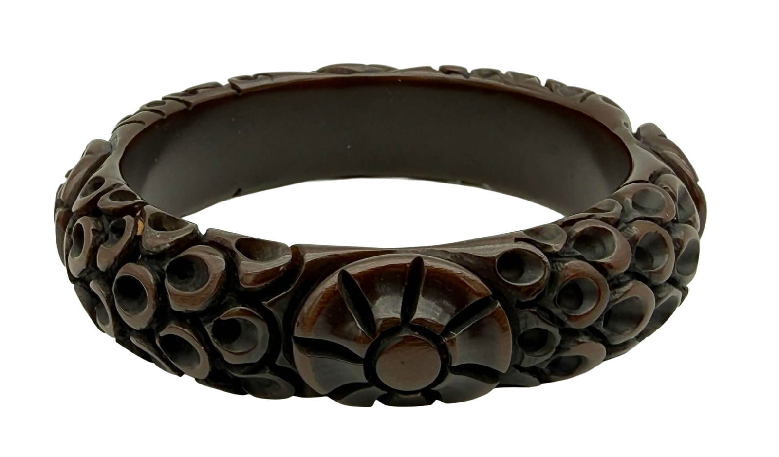 Carved Bakelite Bangle Bracelet with Dot Cluster & Floral Medallions, 1930s–1940s – New York: Vintage carved Bakelite bangle bracelet dating to the 1930s–1940s, featuring an unusual and highly textural design composed of clustered recessed circular “dot” elements interspersed with ca