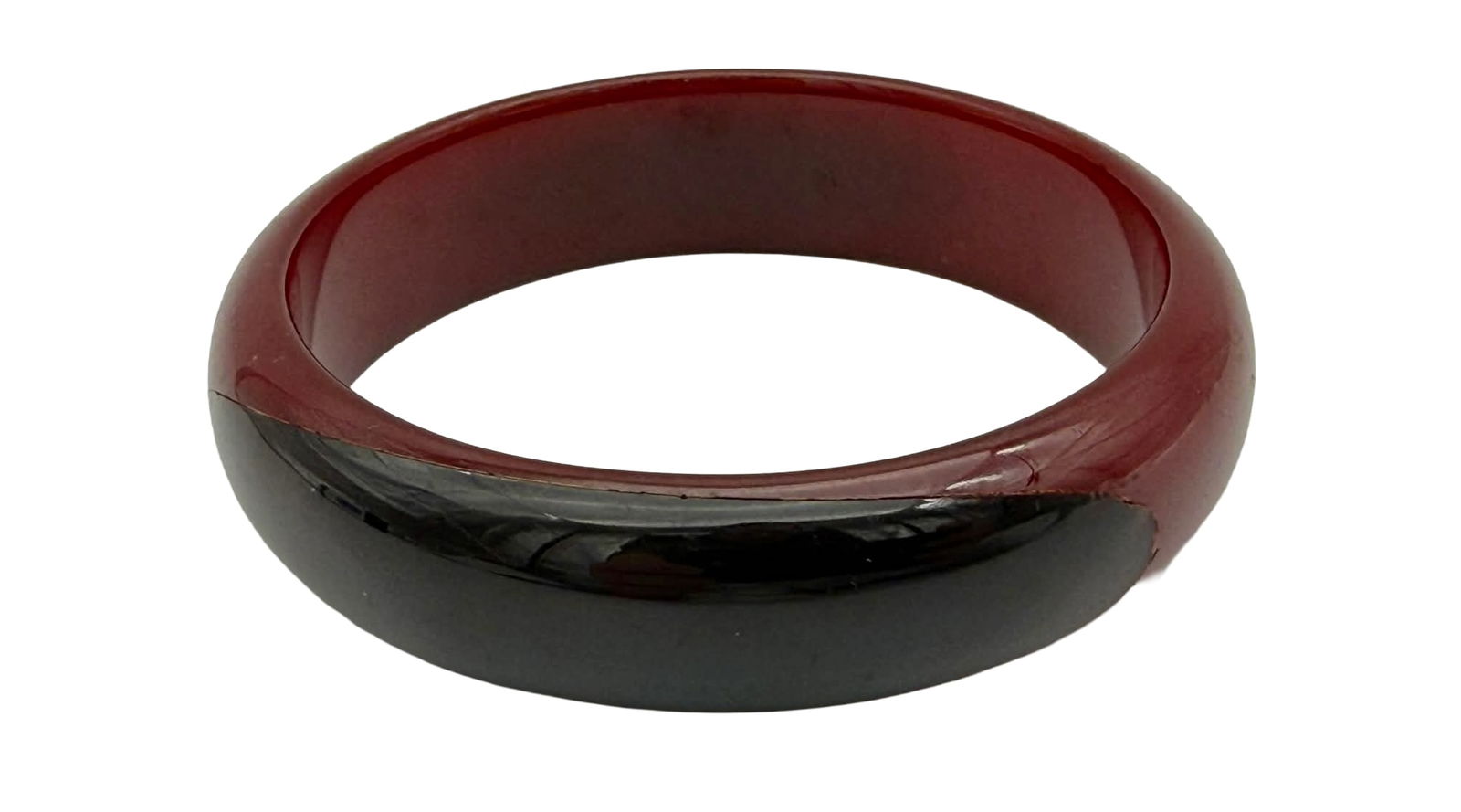 Rare Two-Dot Catalin Bangle Bracelet, Red and Black, 1930s – New York Studio Collection: Rare vintage Catalin bangle bracelet dating to the 1930s, featuring a clean, rounded form with a striking two-tone color composition. The bracelet displays a rich translucent red upper body contrasted