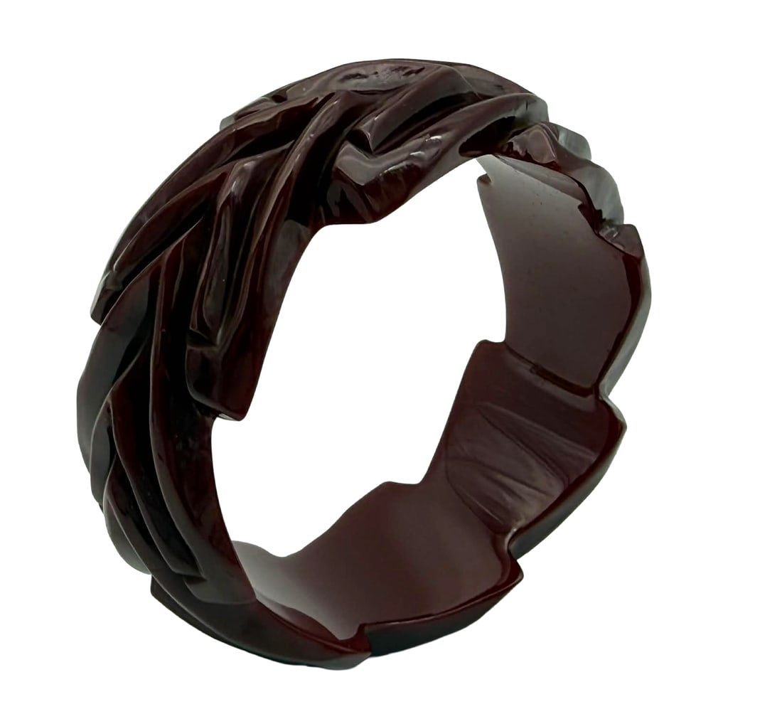 Deeply Carved Catalin Bangle Bracelet, Sculptural Abstract Form, 1930s–1940s – New York Studio: Exceptional vintage Catalin bangle bracelet dating to the 1930s–1940s, featuring bold, deeply carved sculptural elements throughout the exterior. The bracelet is rendered in a rich translucent cherr