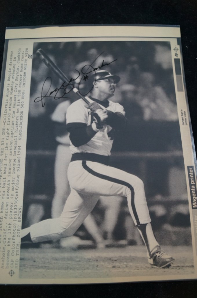 Reggie Jackson Signed Photo Print, California Angels: Signed photo print of Reggie Jackson from the California Angels baseball team. Has info along left corner of print. This is an Associated Press copy photo. Signature can't be verified. About 8 x 10" i