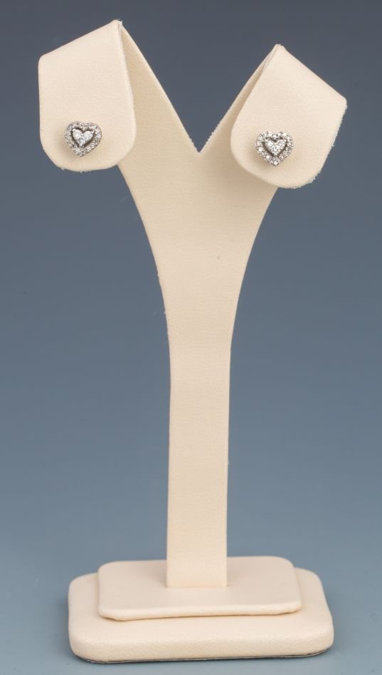 WHITE GOLD DIAMOND HEART SHAPE STUD EARRINGS: WHITE GOLD DIAMOND HEART SHAPE STUD EARRINGS 10k white gold stud earrings featuring 3 - 0.02CT round center diamonds mounted in a heart shape. Heart shaped frame of 18 approximately .01ct accent diamo
