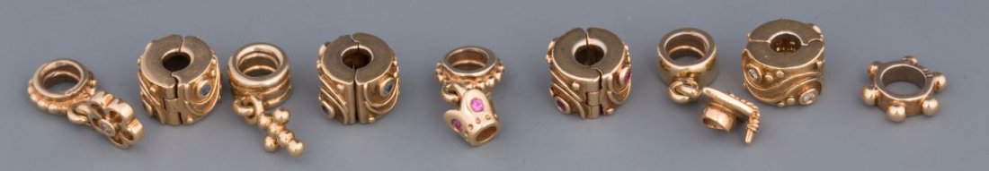 (9) 14K YELLOW GOLD PANDORA BEADS: (9) 14K YELLOW GOLD PANDORA BEADS Nine 14K gold Pandora beads including: five decorative style beads, and four more including a cross, flower, crown, and graduation bead. Six of the beads include smal