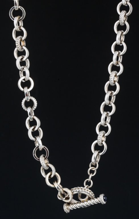 JUDITH RIPKA DESIGNER STERLING TOGGLE NECKLACE: JUDITH RIPKA DESIGNER STERLING TOGGLE NECKLACE 18in Judith Ripka sterling silver toggle necklace. Smooth round links alternate every 6 links to a textured design. Toggle features a cabochon blue sapph