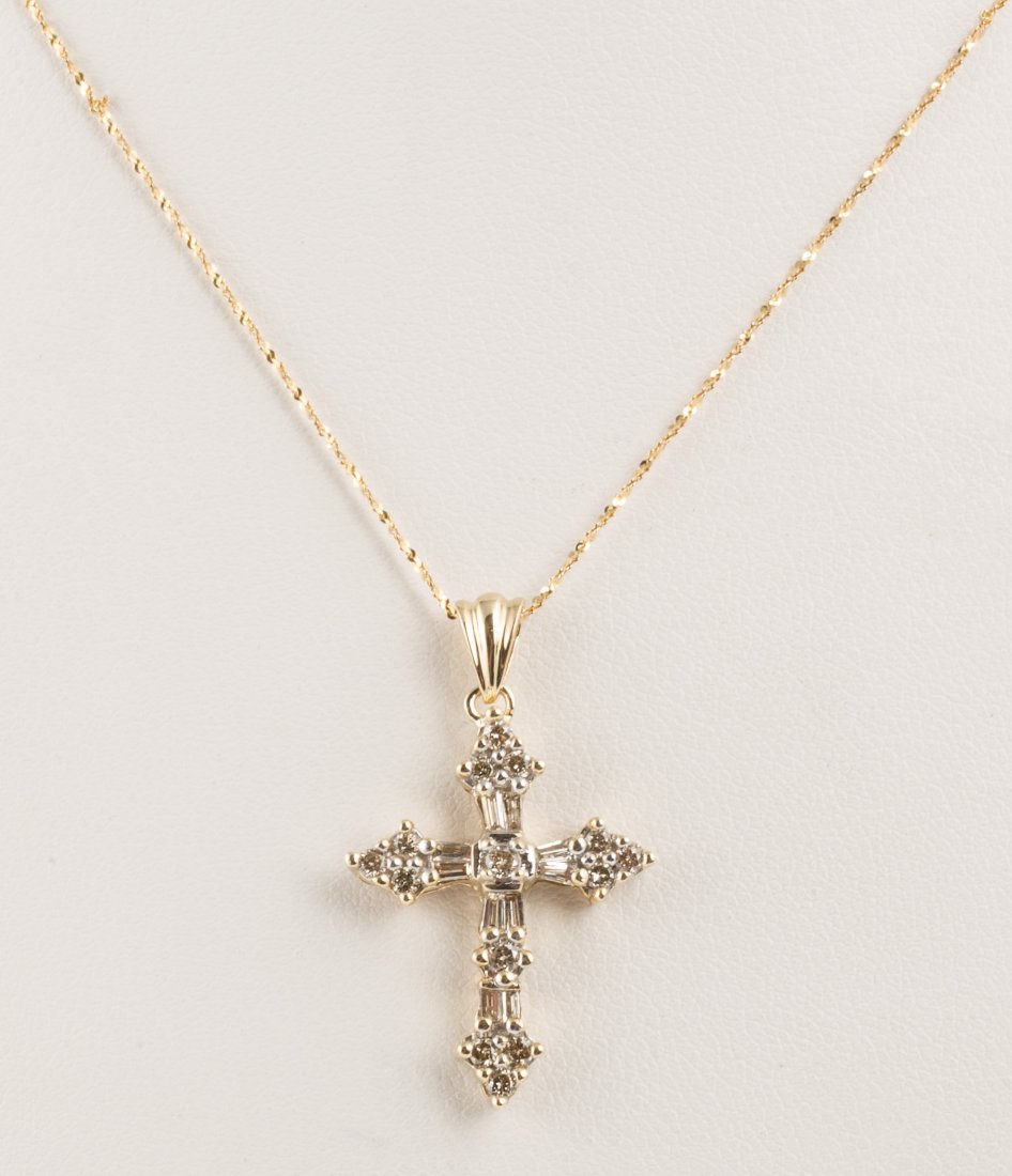 14K DIAMOND CROSS PENDANT NECKLACE: 14K DIAMOND CROSS PENDANT NECKLACE Ladies' 14k yellow gold cross pendant necklace. Pendant includes ten baguette and fourteen brilliant round diamonds, totaling .48ctw, K - SI2 clarity. Weight: 3.5 g 