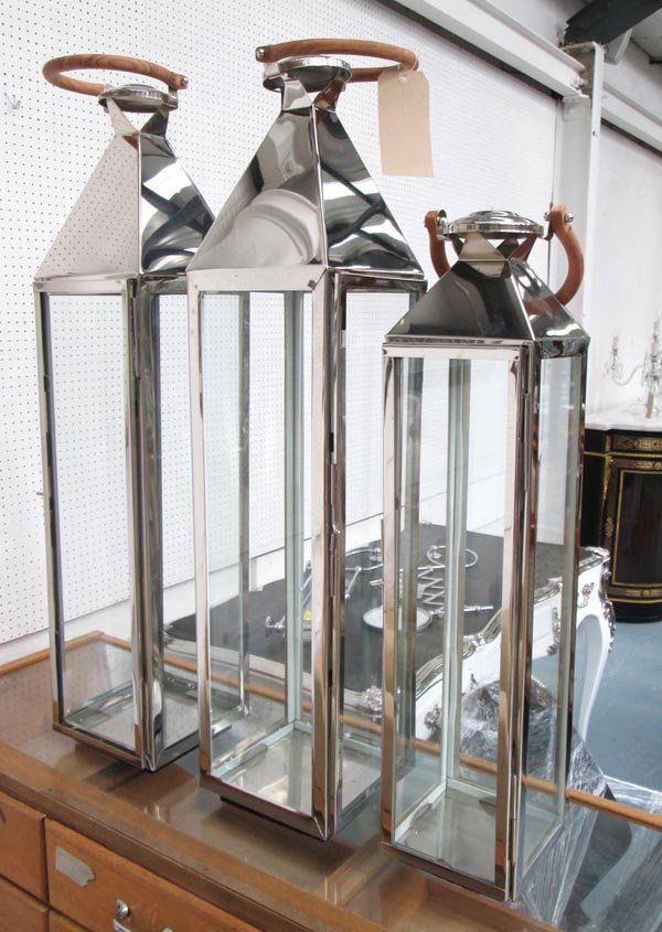CANDLE LANTERNS, a set of three, chrome and glass,