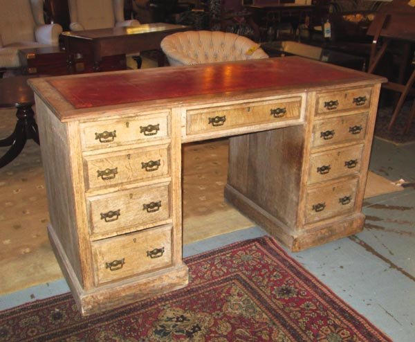 PEDESTAL DESK, Edwardian oak with a rectangular red: PEDESTAL DESK, Edwardian oak with a rectangular red leather tooled top and nine small drawers below, 137cm x 76cm H x 62cm. (as found)