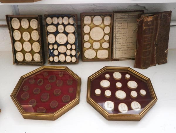 PLASTER INTAGLIOS, 19th century, as previous lots, six: PLASTER INTAGLIOS, 19th century, as previous lots, six in glazed octagonal frames and four mounted as books, one with partial handwritten list. (af, 'books' in poor condition, some intaglios missing)