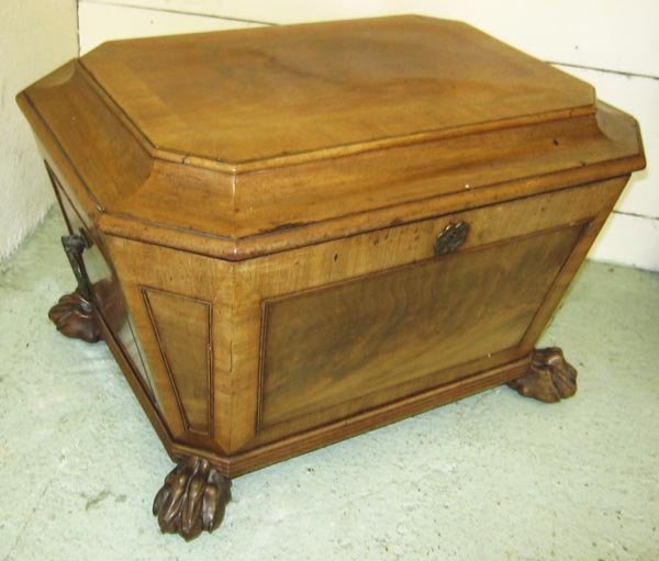 WINE COOLER, George IV mahogany of sarcophagus form: WINE COOLER, George IV mahogany of sarcophagus form with hinged crossbanded top and bronze wreath handles on carved paw feet and castors, 41cm H x 64cm W x 46cm D. (as found)