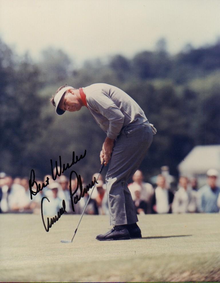 Arnold Palmer: A color action shot putting on the green by the legendary golfer with COA