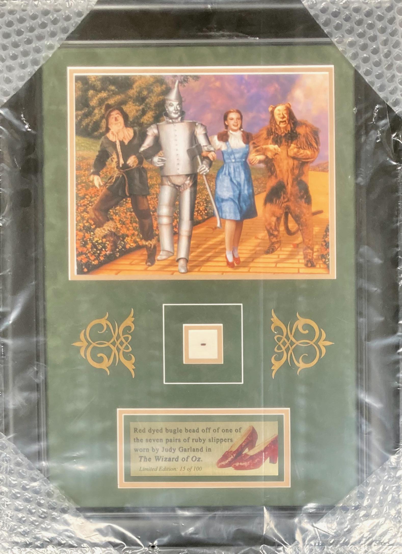 Wizard of Oz bead from DOROTHYS Red Slipper !!: WOW ok so the last sale of her slippers whch netted two MILLION came a strand of red dyed bugle beads from a bow on one pair saved by Kent Warner this is documented with COA one of only 100 in the WOR