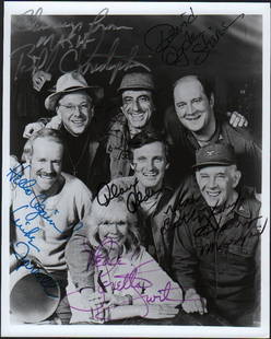 MASH rare complete cast signed photograph: A bw vintage signed 8x10 by entire cast with rare David Ogden Stiers and Alan Alda Loretta Swit Bill Christopher Jamie Farr Harry Morgan and Mike Farrell with COA