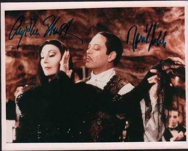 Addam's Family Movie cast: A color vintage signed 8x10 by both stars Raul Julia (deceased) and Angelica Huston with COA