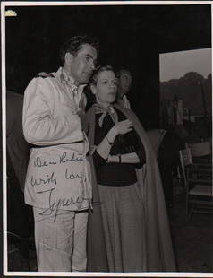 Tyrone Power signed photograph: A heavyweight sepia toned 8x10 by the swahsbuckling actor signed Tyrone in fountain pen ink with COA