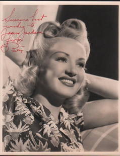 Betty Grable signed photograph: A heayweight sepia toned signed 8x10 by the WWII pin up and actress with COA