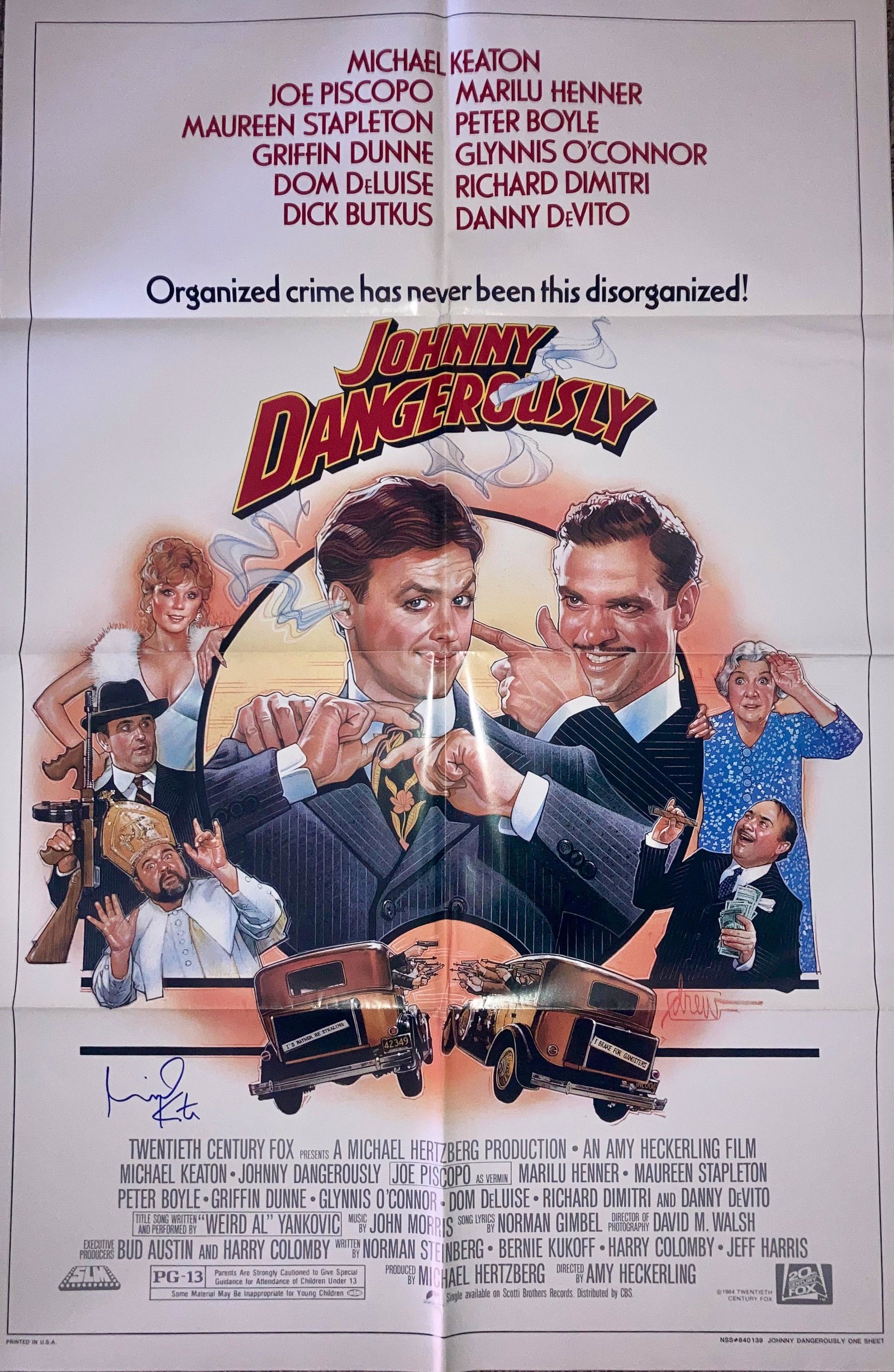 Johnny Dangerously movie poster signed: An original movie poster signed by Michael Keaton with COA