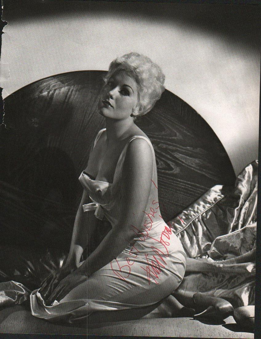 Kim Novak signed photograph: A killer larger 9x12 photo taken from a coffee table book and signed in person to a man who was the newspaper interviewer for entertainment for San Francisco paper for 50 years with COA
